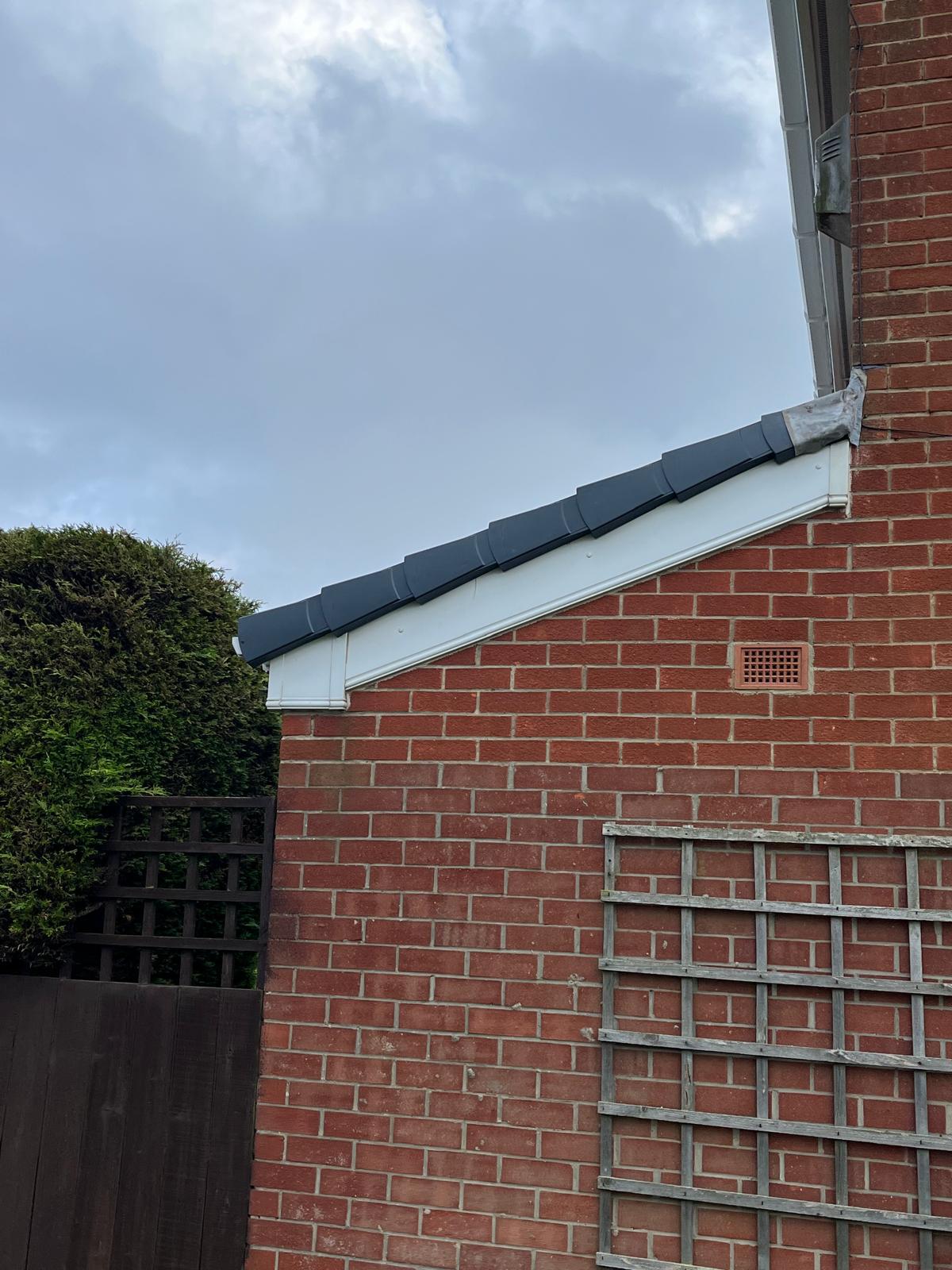 New grey dry verge system fitted to a gable end by Ackroyd & Son Roofing
