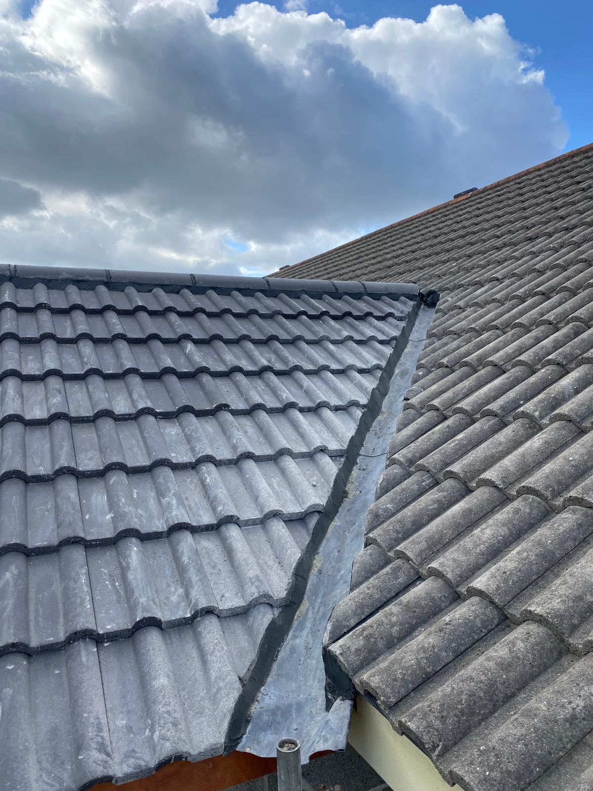 New lead valley fitted between two pitched tiled roofs &mdash; UK roof junction